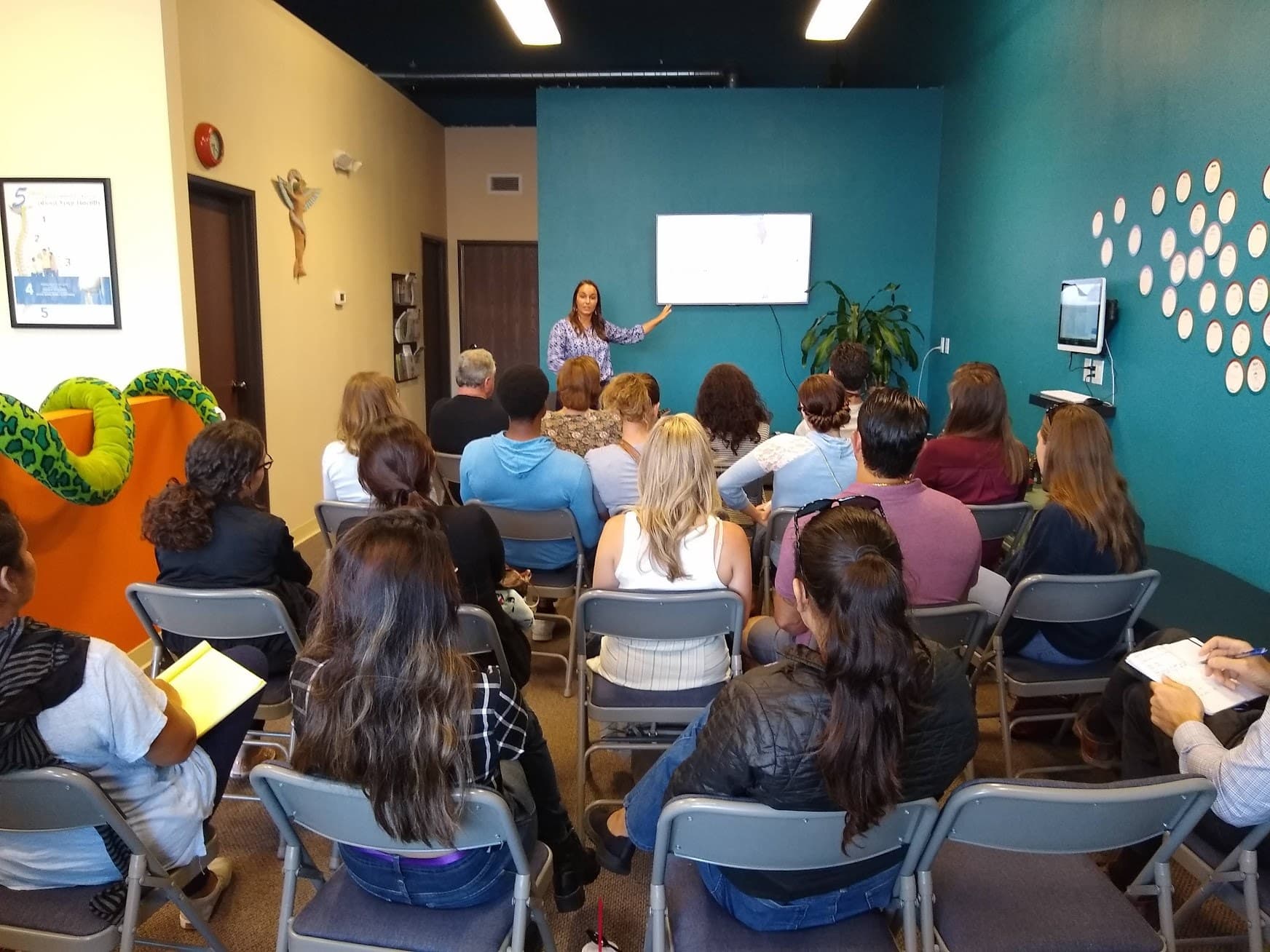 A member presenting to a packed room of attendees