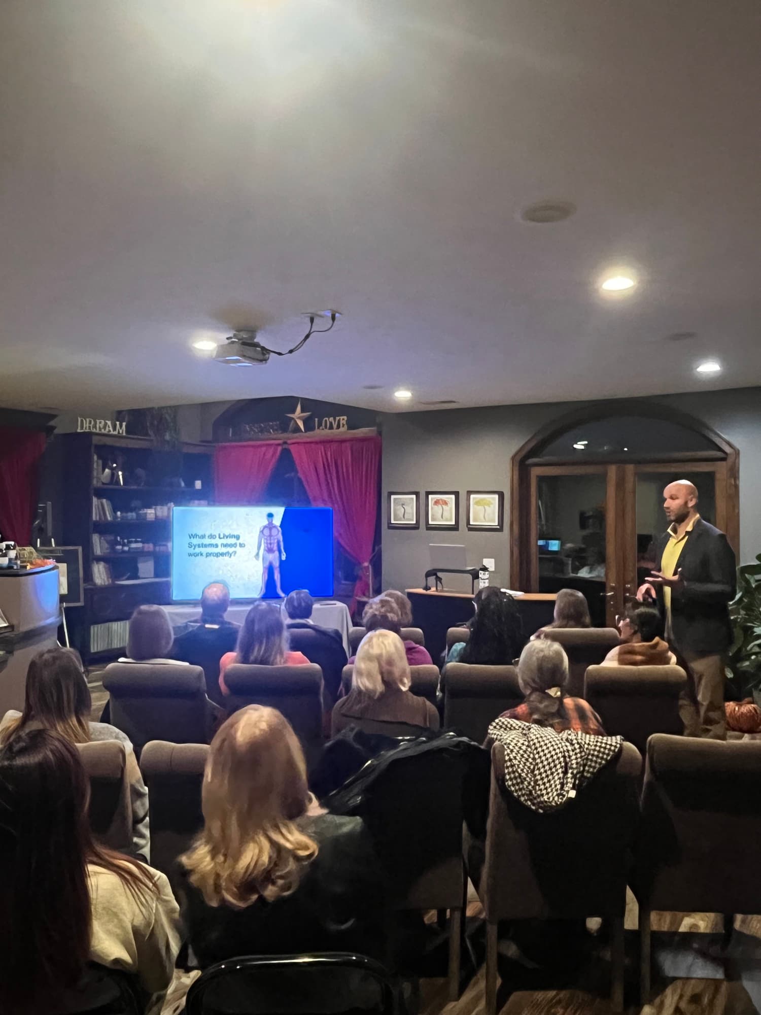 A workshop in progress, a full room facing the presenter